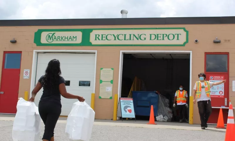 Person carrying bags of styrofoam to be dropped off at the Markham recycling depot.