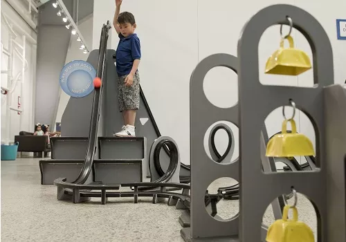 child learning and playing with a display in the museum