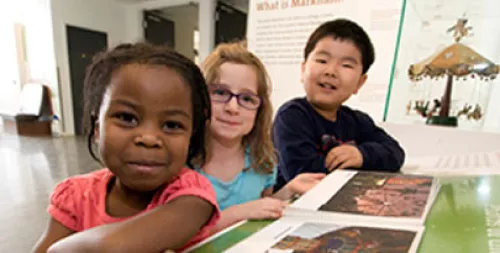 kids smiling as they read