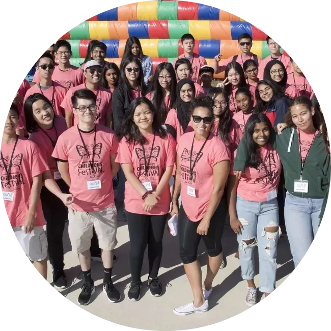 Group of volunteers in pink shirts.